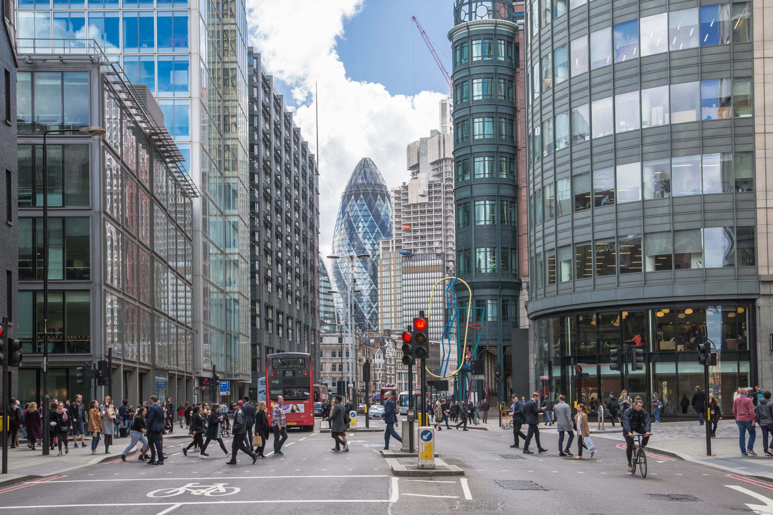 London, UK.  City of London busy street with view  with lots of people crossing the road, cars and buses